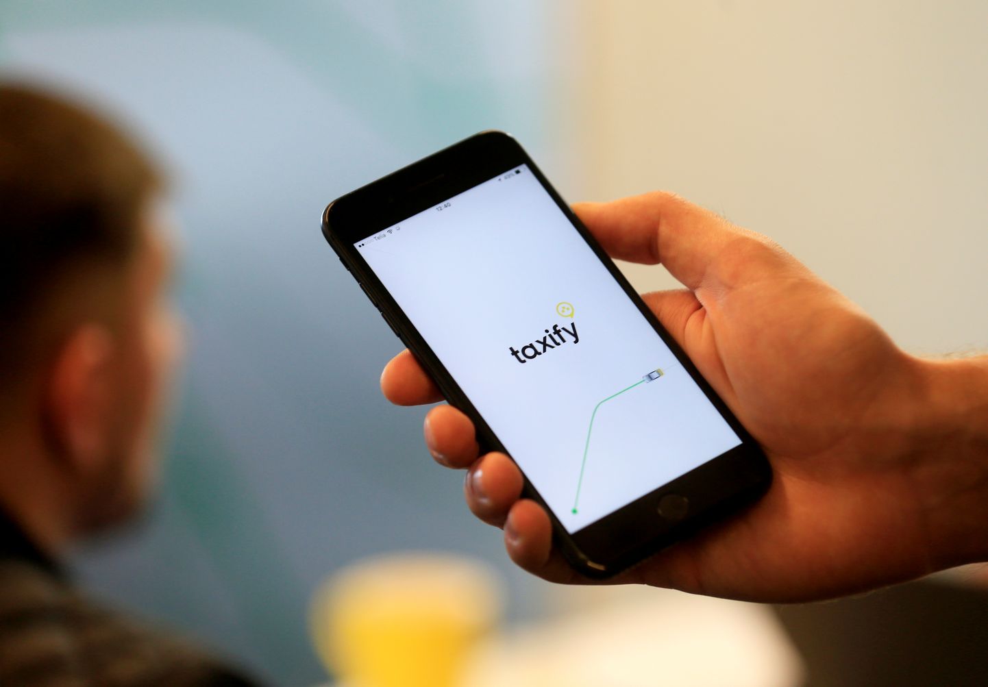 Taxify CEO Markus Villig shows a smartphone app at company's headquarters in Tallinn, Estonia, June 13, 2017. Picture taken June 13, 2017. REUTERS/Ints Kalnins