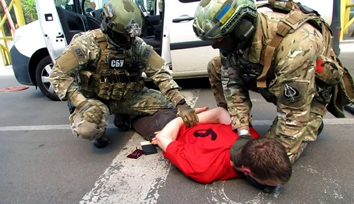 In this image, provided by the Ukrainian Intelligence Agency SBU on Monday, June 6, 2016, SBU agents detain a suspect at the Yahodyn border crossing on the Ukrainian-Polish border, Ukraine. Ukraine's intelligence agency SBU said on Monday it has thwarted a plot to attack soccer's European Championships in France by arresting a Frenchman who wanted to cross from Ukraine into the European Union armed to the teeth. (Ukraine's Intelligence Agency SBU Press Service photo via AP)