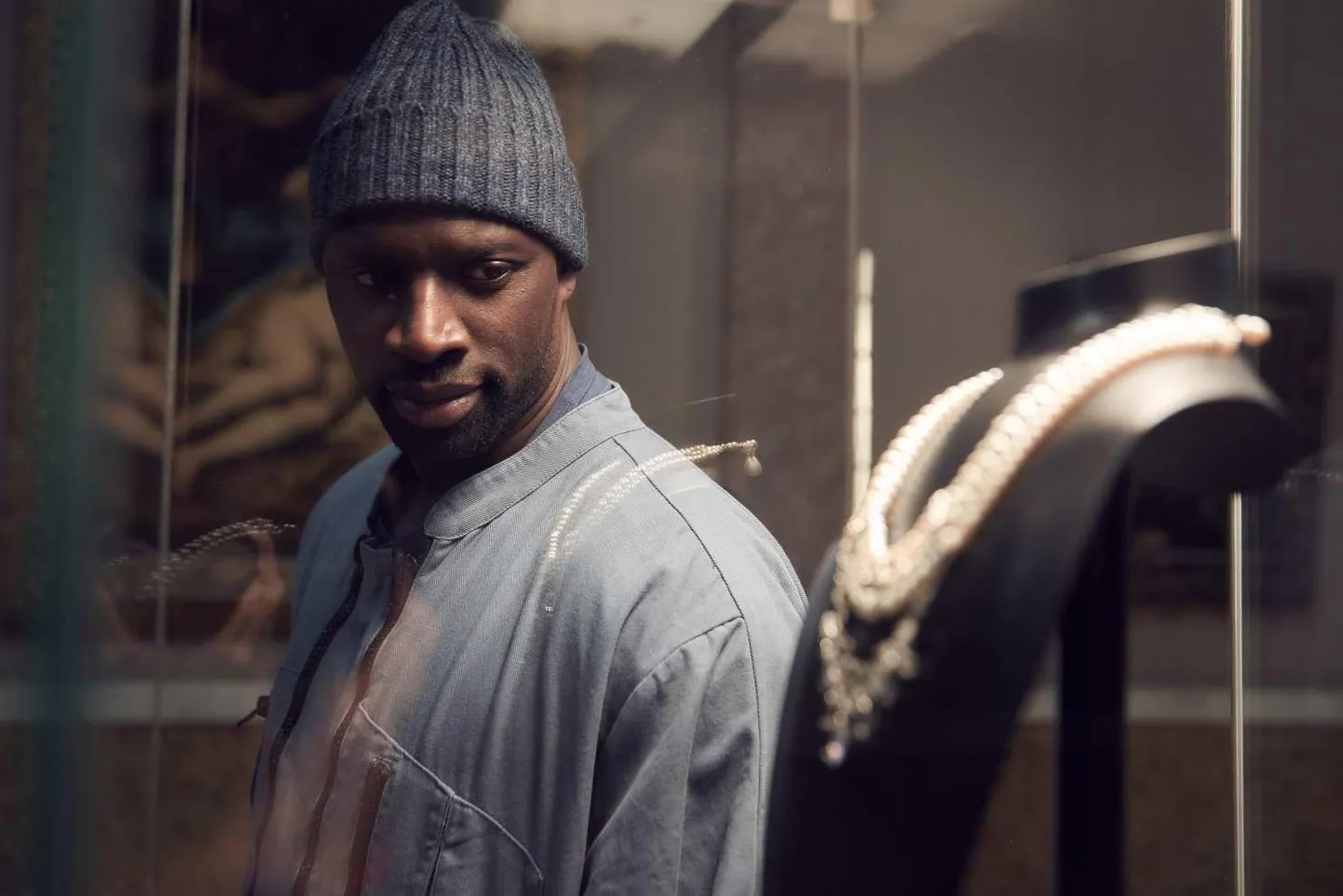 Omar Sy kehastatud meistervaras Lupin vaatab saatuslikku kaelakeed, mille ta ka kohe ära varastab.