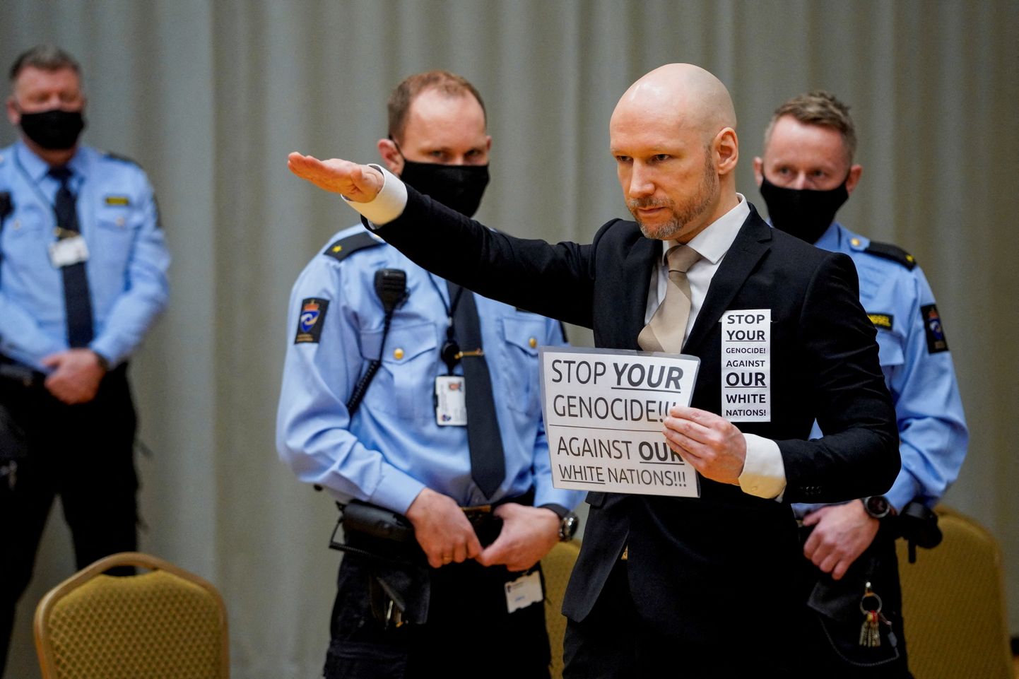 Mass killer Anders Behring Breivik, gestures while holding a sign, on the first day of the hearing, where he is requesting release on parole, at the makeshift courtroom in Skien prison, Norway January 18, 2022. NTB/Ole Berg-Rusten via REUTERS

ATTENTION EDITORS - THIS IMAGE WAS PROVIDED BY A THIRD PARTY. NORWAY OUT. NO COMMERCIAL OR EDITORIAL SALES IN NORWAY.